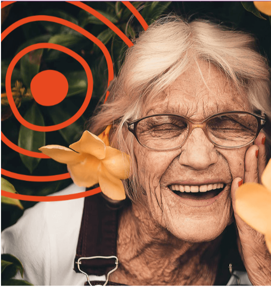 A woman wearing glasses smiling with her eyes closed.