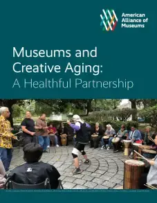 On a dark green background is written, "American Alliance of Museums" in the upper right corner followed by the title "Museums and Creative Aging: A Healthful Partnership" beneath that is a photo of a group of people in a circle enjoying an outdoor activity.