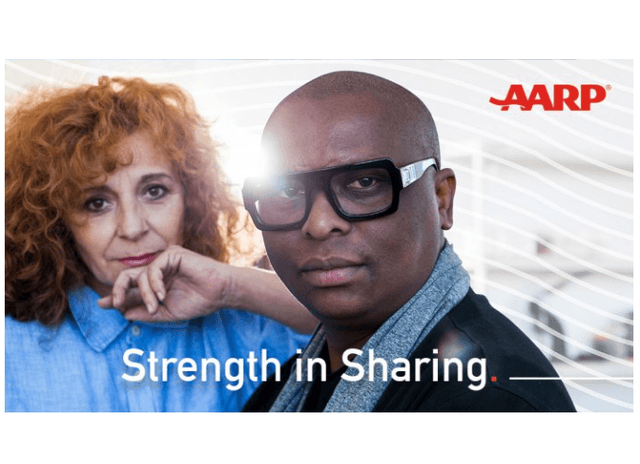 A man standing with the sun shining behind them and the text "Strength in Sharing. The AARP logo is in the upper left corner